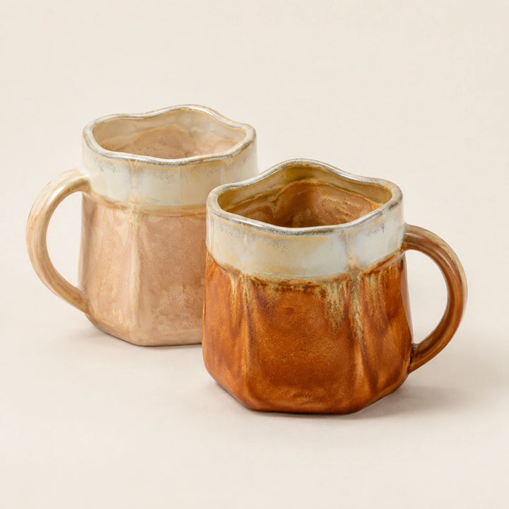 Cloud and Amber two-mug set with one pale and one amber reactive-glaze ceramic mug, both fully shown.