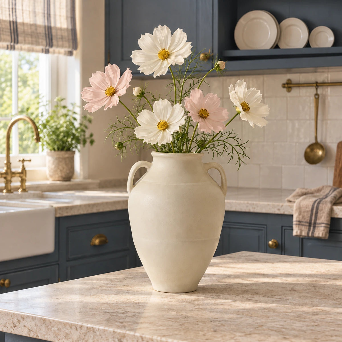 Ivory petite-handle vase with cream and blush cosmos flowers on a limestone counter in a blue country kitchen