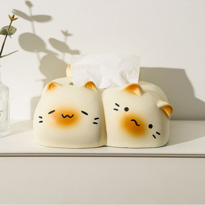 Two cute animal-shaped tissue boxes on a white surface with a light background