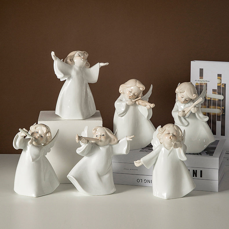 Set of white angel figurines on a brown background