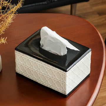 Tissue box with white tissue on a wooden table