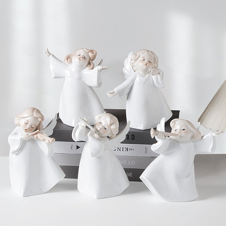 Set of white angel figurines on a light gray background