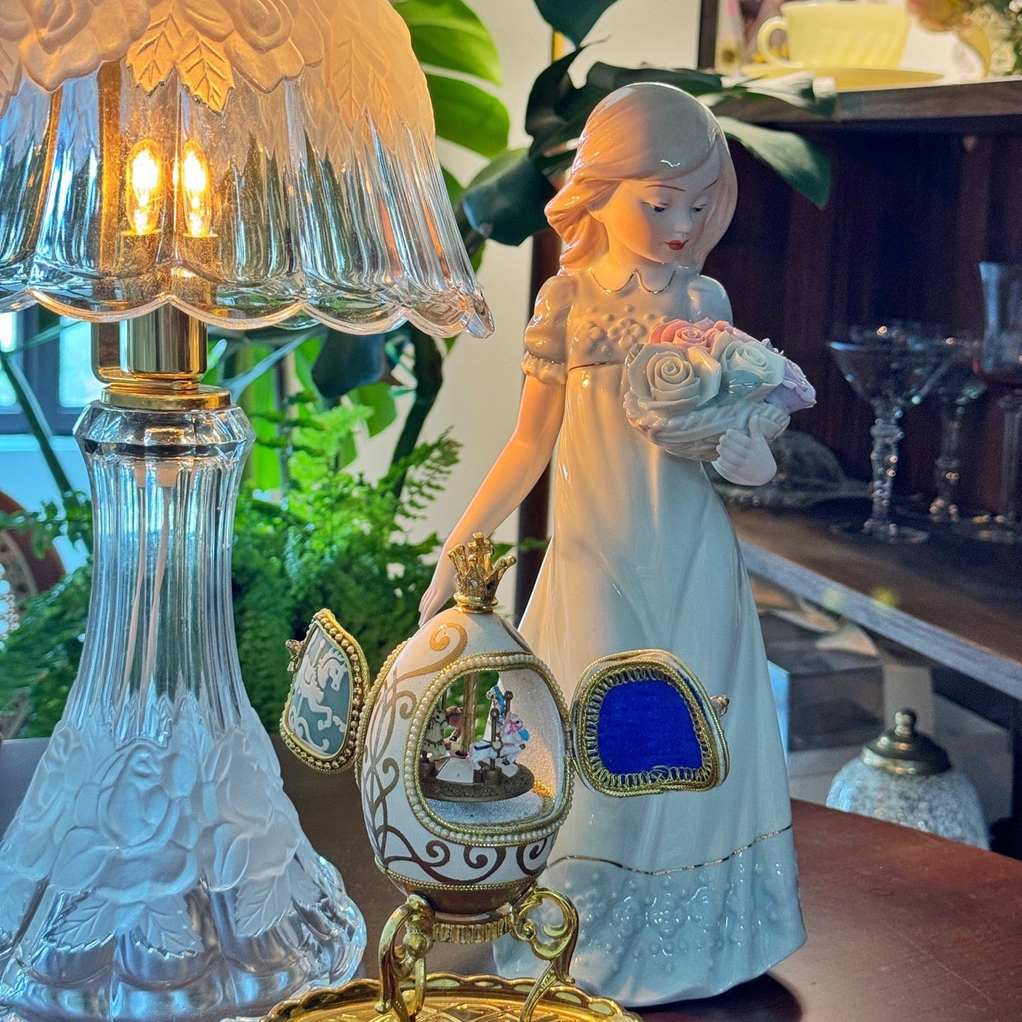 Decorative lamp with a figurine of a woman holding a bouquet in a home setting.
