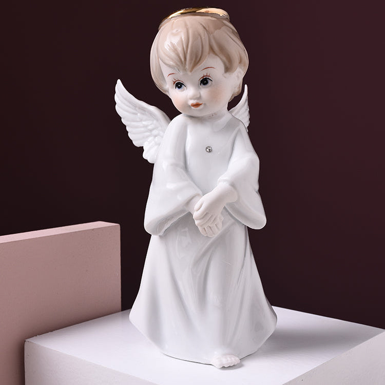 White ceramic angel figurine on a dark background