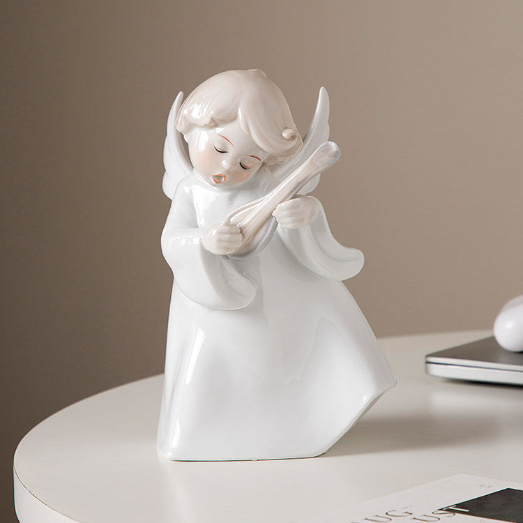 White angel figurine on a round white surface with a neutral background