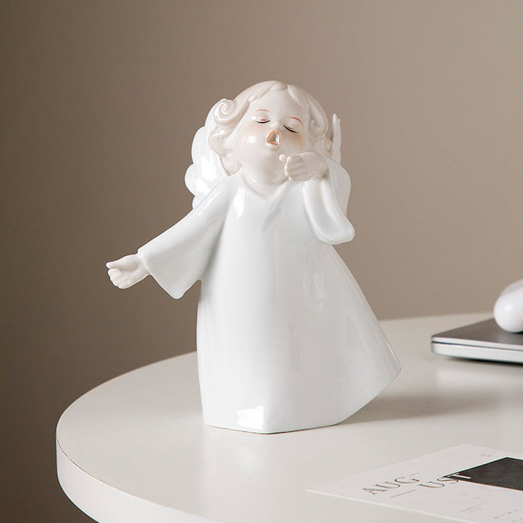 White angel figurine on a round white platform with a neutral background