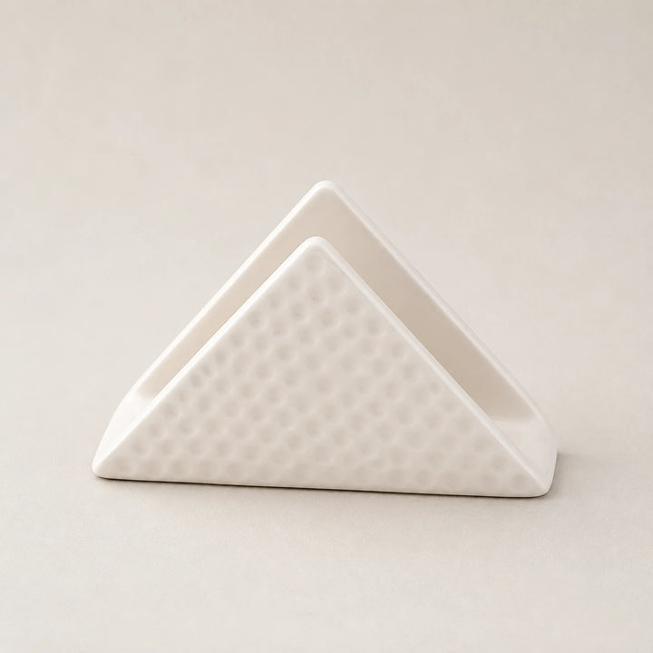 White triangular ceramic napkin holder with dimpled outer panels