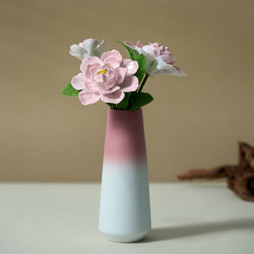 Vase with pink flowers on a beige background