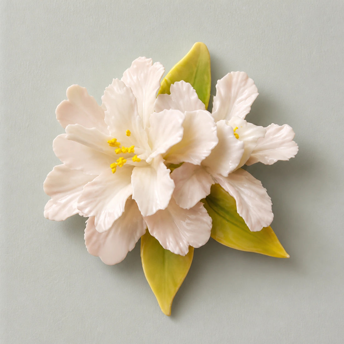 Hand-shaped blush and white ceramic crabapple refrigerator magnet on a pale mineral-sage background.