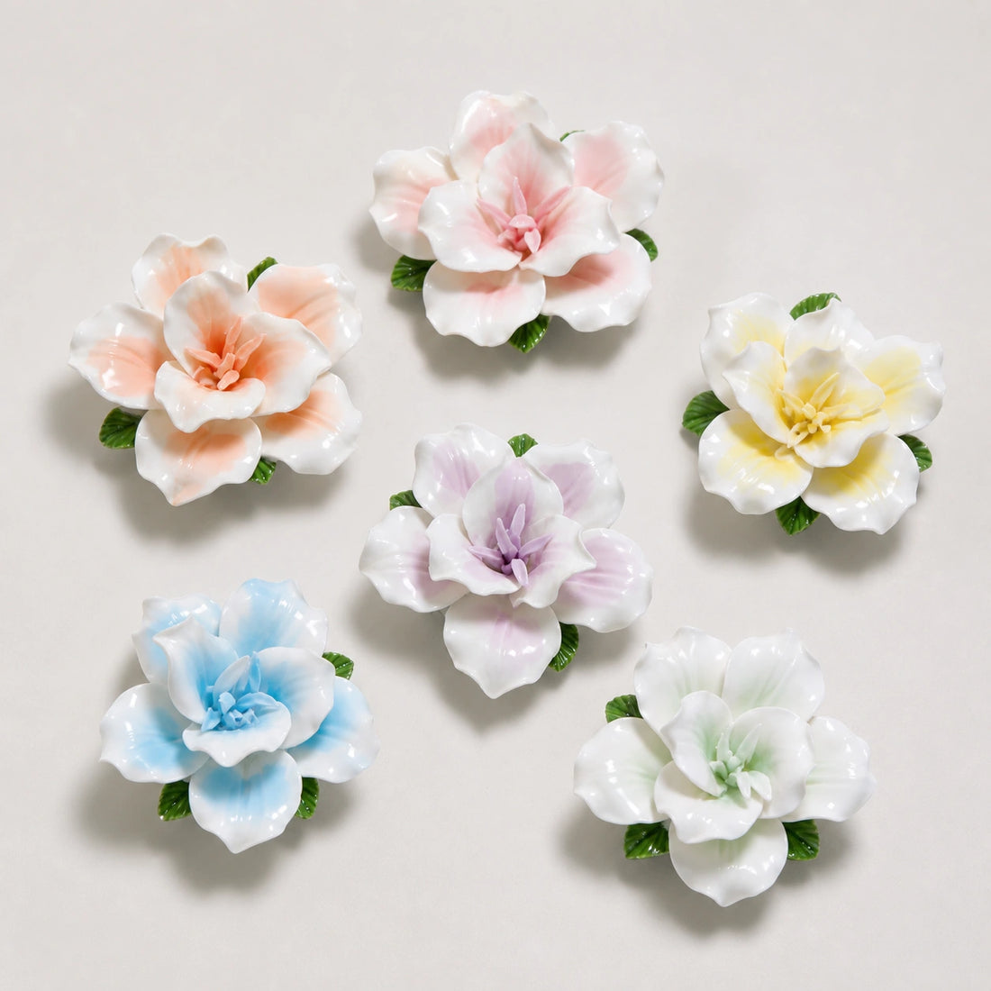 Six ceramic lily refrigerator magnets in pink, orange, yellow, lavender, blue and pale green.