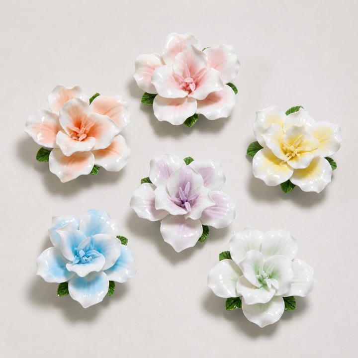 Six ceramic lily refrigerator magnets in pink, orange, yellow, lavender, blue and pale green.
