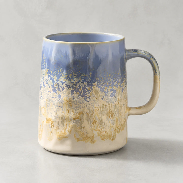 Cloud Blue layered-glaze ceramic mug on a light pearl-gray studio background.