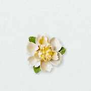 Medium Ruffled Peony Ceramic Wall Flower in Golden Yellow Accent on a pale neutral studio wall.