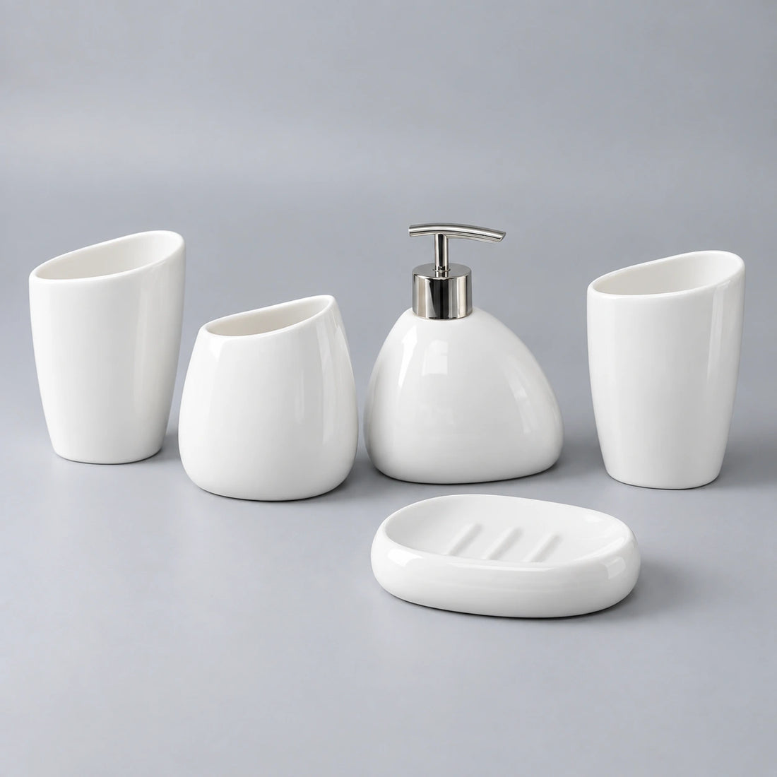 Elevated view of the Arc White five-piece set showing curved cup openings and soap dish ridges.
