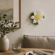 Medium Lotus Bloom Ceramic Wall Flower in Golden Yellow Accent mounted above a neutral banquette on a dining wall.