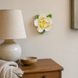 Small Ruffled Peony Ceramic Wall Flower in Golden Yellow Accent mounted above a small ceramic lamp in a guest room.