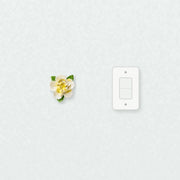 Small Ruffled Peony Ceramic Wall Flower in Golden Yellow Accent beside a plain light-switch wall plate for scale.