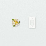 Medium Ruffled Peony Ceramic Wall Flower in Golden Yellow Accent beside a plain light-switch wall plate for scale.