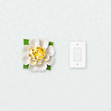 Extra Large Ruffled Peony Ceramic Wall Flower in Golden Yellow Accent beside a plain light-switch wall plate for scale.