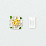 Extra Large Ruffled Peony Ceramic Wall Flower in Golden Yellow Accent beside a plain light-switch wall plate for scale.
