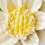 Close view of the golden yellow accent center and glazed petals on Medium Lotus Bloom Ceramic Wall Flower.