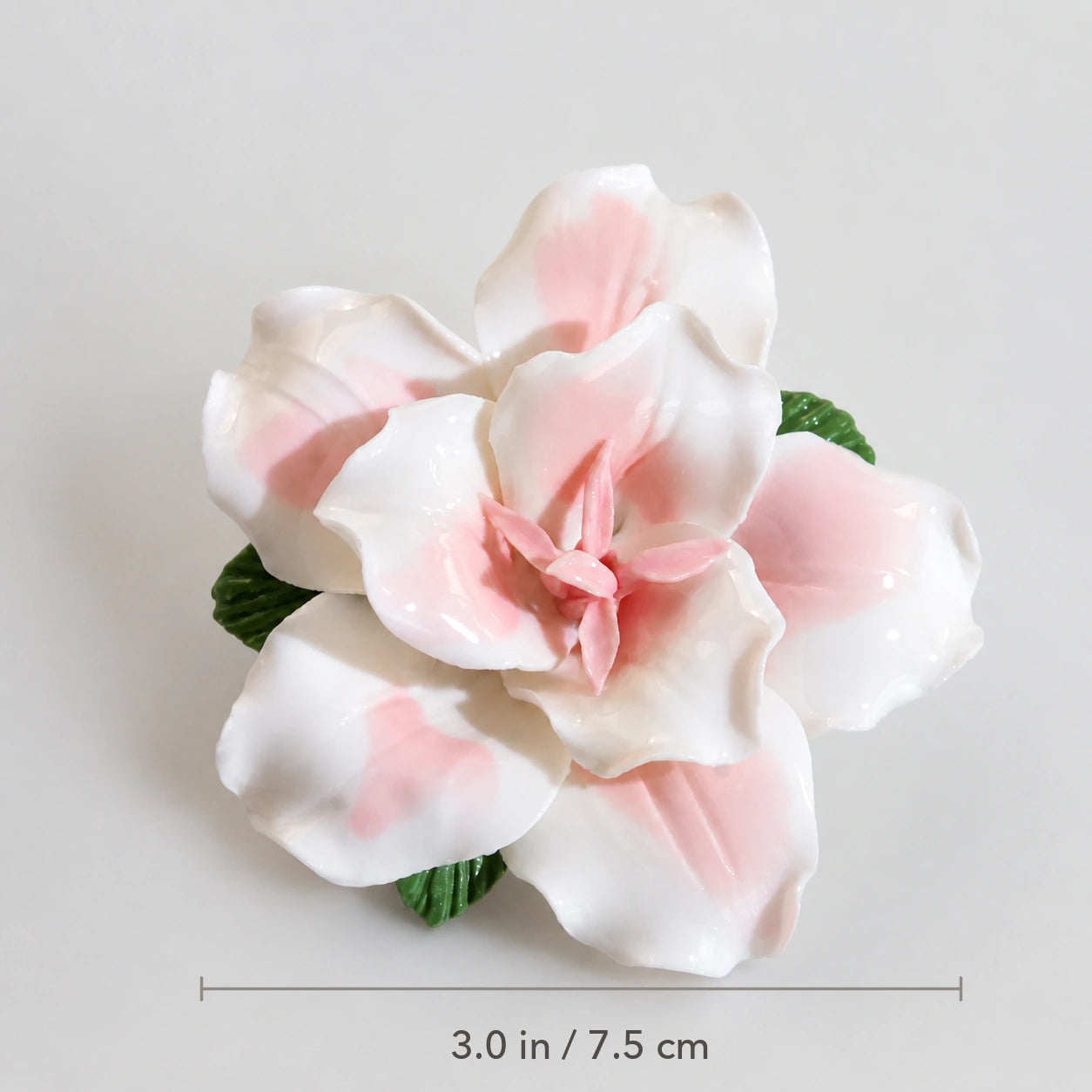 Blush pink ceramic lily magnet with diameter marked as 3.0 inches or 7.5 centimeters.