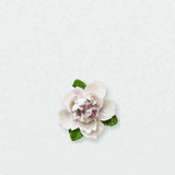 Small Ruffled Peony Ceramic Wall Flower in Plum Purple Accent on a pale neutral studio wall.