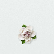 Small Ruffled Peony Ceramic Wall Flower in Plum Purple Accent on a pale neutral studio wall.