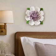 Extra Large Ruffled Peony Ceramic Wall Flower in Plum Purple Accent mounted beside a reading sconce on a guest-bedroom wall.