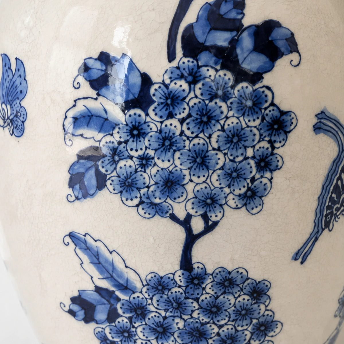 Close-up of cobalt petal outlines, leaves and crackle glaze on the large vase.