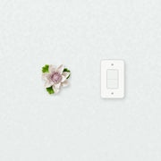 Medium Lotus Bloom Ceramic Wall Flower in Plum Purple Accent beside a plain light-switch wall plate for scale.