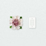 Extra Large Ruffled Peony Ceramic Wall Flower in Plum Purple Accent beside a plain light-switch wall plate for scale.