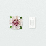 Extra Large Ruffled Peony Ceramic Wall Flower in Plum Purple Accent beside a plain light-switch wall plate for scale.