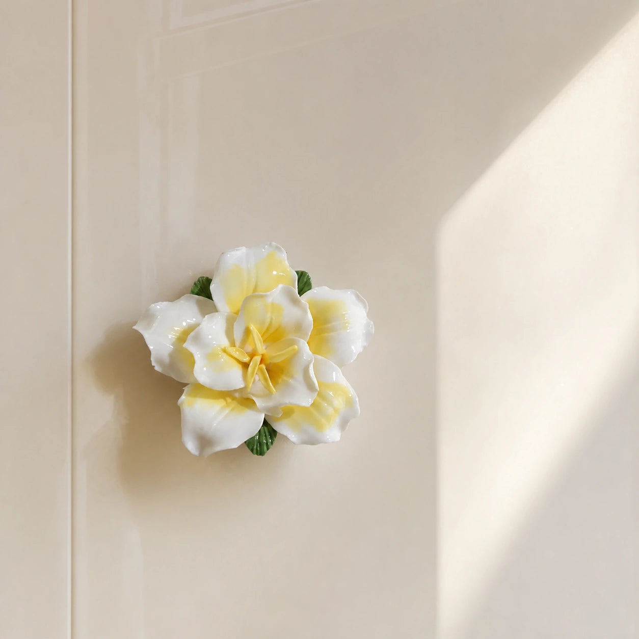 Butter yellow ceramic lily magnet in a warm sunlit kitchen-panel composition.