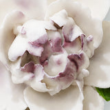 Close view of the plum purple accent center and glazed petals on Small Ruffled Peony Ceramic Wall Flower.