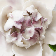 Close view of the plum purple accent center and glazed petals on Small Ruffled Peony Ceramic Wall Flower.