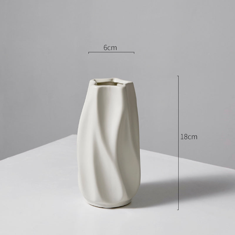 White ceramic vase with twisted texture standing on white surface, dimensions 6cm width and 18cm height