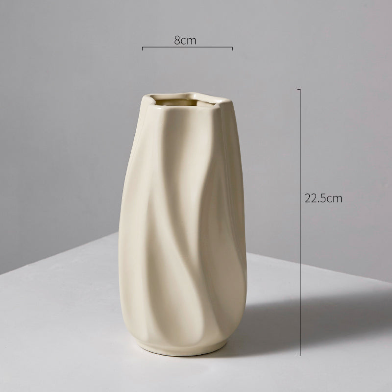 Minimalist beige ceramic vase with smooth, twisted design, 22.5cm tall and 8cm wide