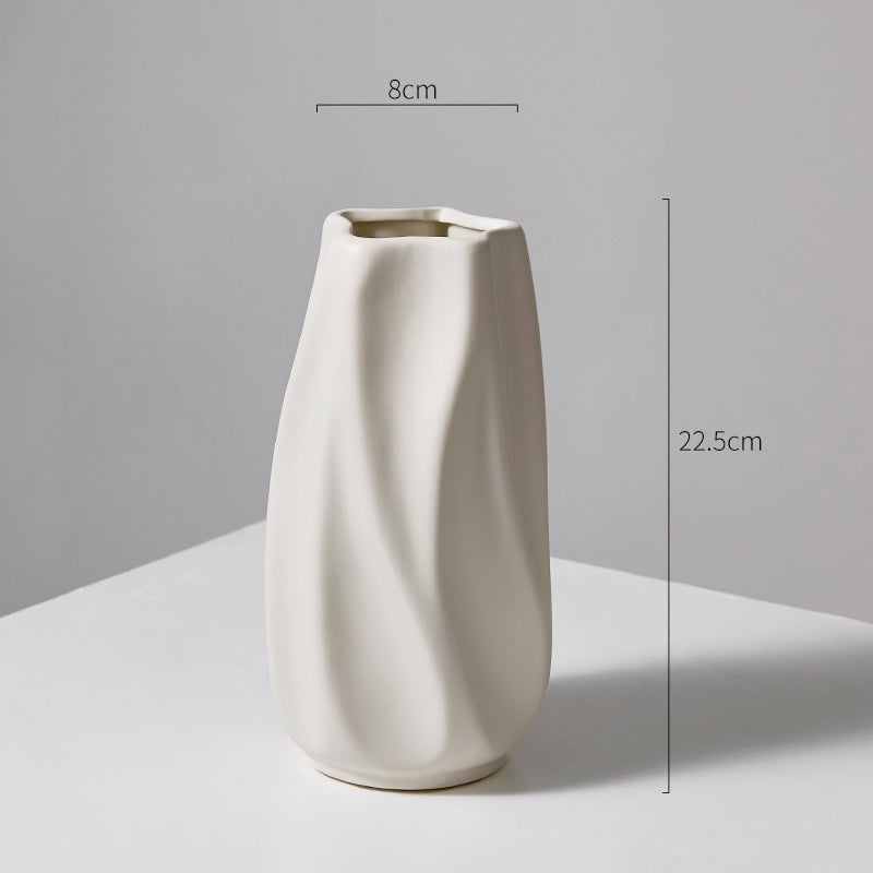 Minimalist white ceramic vase with irregular twisted design, measuring 22.5cm height and 8cm width