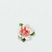 Small Ruffled Peony Ceramic Wall Flower in Rose Red Accent on a pale neutral studio wall.