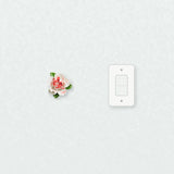 Small Ruffled Peony Ceramic Wall Flower in Rose Red Accent beside a plain light-switch wall plate for scale.