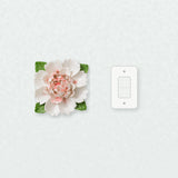 Extra Large Ruffled Peony Ceramic Wall Flower in Rose Red Accent beside a plain light-switch wall plate for scale.