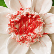 Close view of the rose red accent center and glazed petals on Medium Lotus Bloom Ceramic Wall Flower.