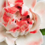 Close view of the rose red accent center and glazed petals on Small Ruffled Peony Ceramic Wall Flower.