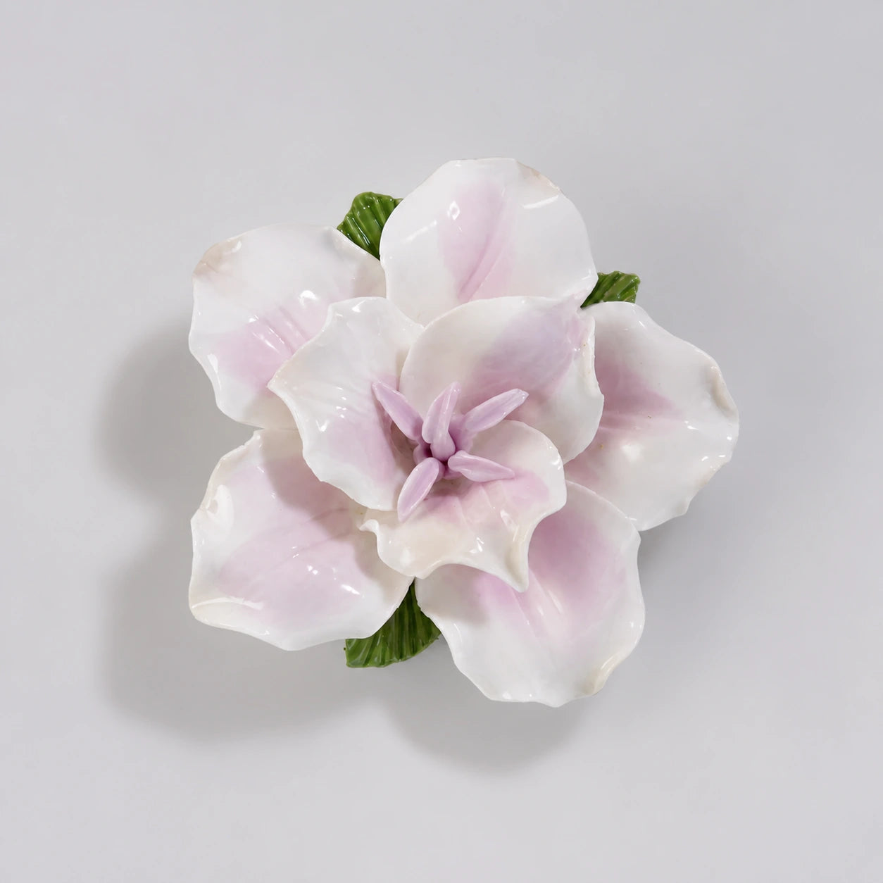 Soft lavender glazed ceramic lily refrigerator magnet on a light pearl-gray background.