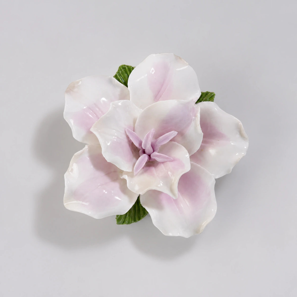 Soft lavender glazed ceramic lily refrigerator magnet on a light pearl-gray background.