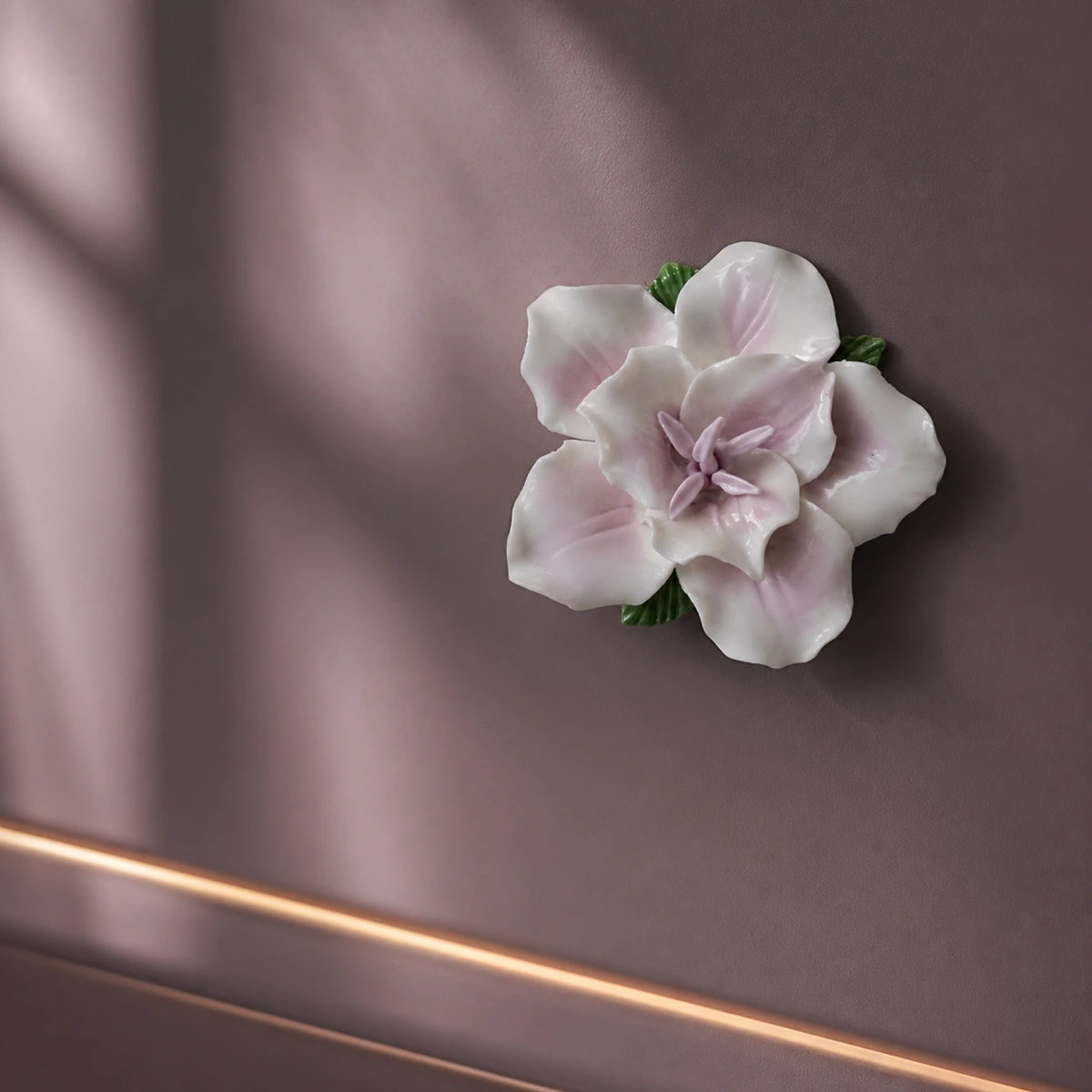 Soft lavender ceramic lily magnet styled on a smoky mauve magnetic cabinet at blue hour.