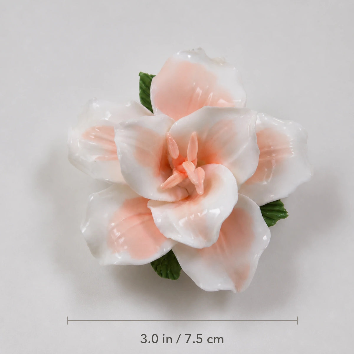 Soft orange ceramic lily magnet with diameter marked as 3.0 inches or 7.5 centimeters.