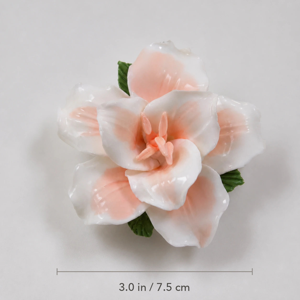 Soft orange ceramic lily magnet with diameter marked as 3.0 inches or 7.5 centimeters.