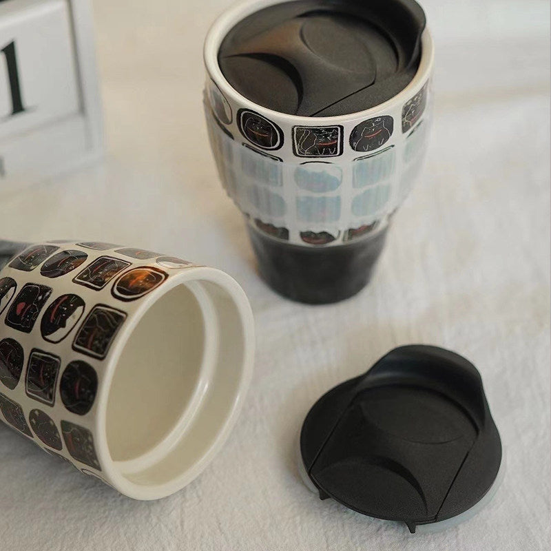 Nocturnal feline ceramic mug set with black lid, clear sleeve and matching open cup